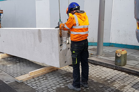 A singer attaching a concrete slab to a crane