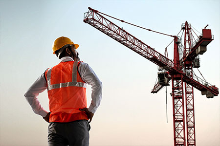 A site supervisior looking at a crane