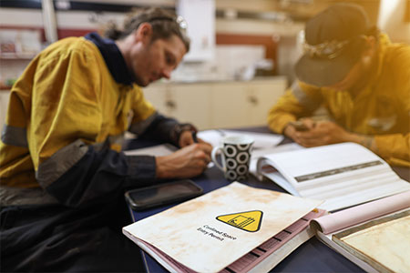 A construction worker filling out risk assesments