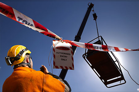 A construction worker marking dangerous areas