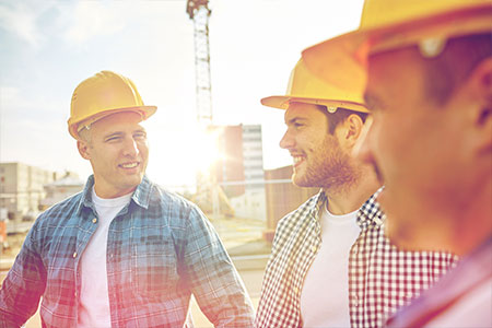 A group of construction workers talking to eachother