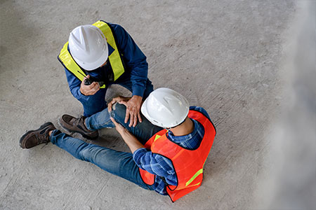 A man helping an injured construction worker