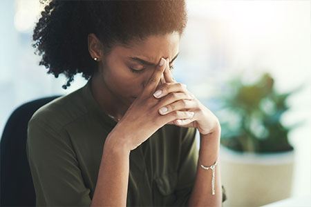 A women looking stressed in an office