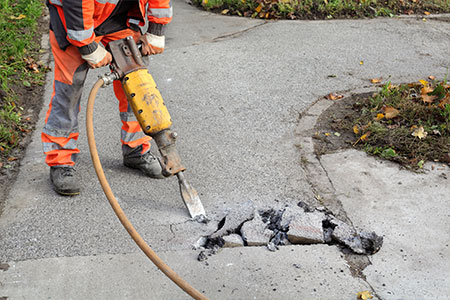 A construction worker using a drill