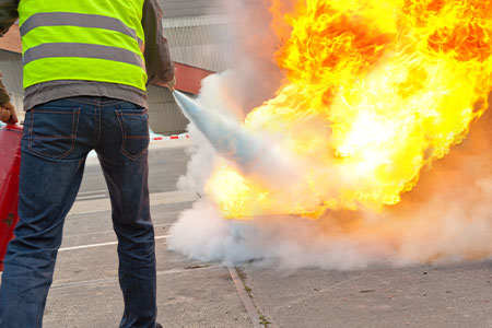 A man testing a fire extinguisher