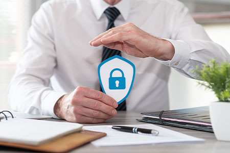 A padlock in a shield being held by an office worker