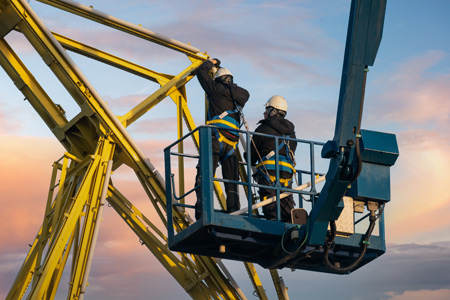 2 builders on a cherry picker