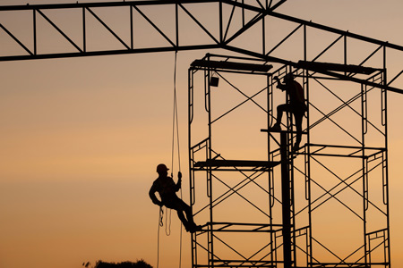 Shadows of construction workers on scaffoling