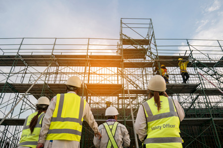 Team of builders walking on a construction site