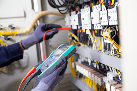 An electrician testing wires