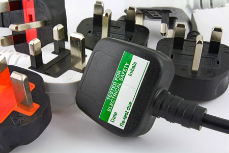 Plugs with PAT testing stickers