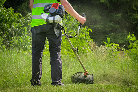 A person using a grass trimmer