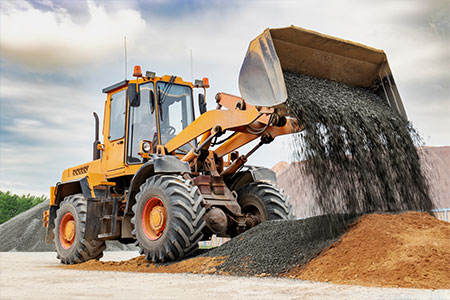 A 180 excavator pouring stones into a pile