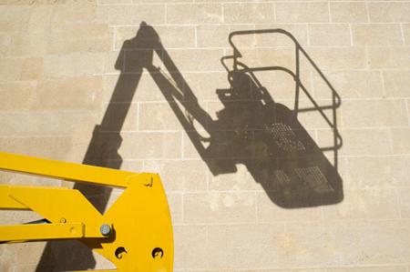 A shadow of a cherry picker